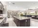 Open-concept kitchen features an island, granite countertops, and dark wood cabinets at 1303 W Cherrywood Dr, Queen Creek, AZ 85140