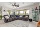 Spacious living room featuring a large sectional, ceiling fan, recessed lighting, and sliding glass doors to the backyard at 1303 W Cherrywood Dr, Queen Creek, AZ 85140