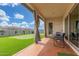 Inviting covered patio overlooking a lush backyard with a putting green for ultimate relaxation and entertainment at 1303 W Cherrywood Dr, Queen Creek, AZ 85140