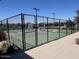A view of fenced-in tennis courts, part of the community's outdoor recreational amenities at 1303 W Cherrywood Dr, Queen Creek, AZ 85140