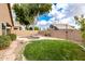 Lush backyard featuring a sparkling pool, green lawn, and serene privacy landscaping at 1447 E Nighthawk Way, Phoenix, AZ 85048