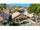 Home boasts a private backyard pool and mature landscaping, creating a serene and inviting outdoor oasis at 1447 E Nighthawk Way, Phoenix, AZ 85048