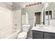 Bright bathroom featuring shower-tub combination and a vanity with sleek countertops and lighting at 1447 E Nighthawk Way, Phoenix, AZ 85048