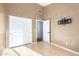 Bedroom showcasing light wood floors and textured walls with mounted bracket at 1447 E Nighthawk Way, Phoenix, AZ 85048