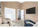 Bright bedroom featuring textured walls, light wood floors, and ample natural light at 1447 E Nighthawk Way, Phoenix, AZ 85048