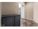 Hallway featuring beautiful slate flooring and built-in storage, leading to a bright room at 1447 E Nighthawk Way, Phoenix, AZ 85048