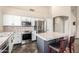 Kitchen features a stainless appliances, white cabinets and an island with seating at 1447 E Nighthawk Way, Phoenix, AZ 85048