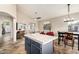 Kitchen features a tiled island with seating, an eat-in area, and tile flooring at 1447 E Nighthawk Way, Phoenix, AZ 85048