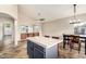 Kitchen features a tiled island with seating, an eat-in area, and tile flooring at 1447 E Nighthawk Way, Phoenix, AZ 85048