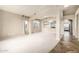 Spacious living room features open floor plan, neutral carpet, and archways leading to other rooms at 1447 E Nighthawk Way, Phoenix, AZ 85048