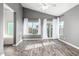 Bright living room with wood floors, ceiling fan, and access to the outdoor patio at 1447 E Nighthawk Way, Phoenix, AZ 85048