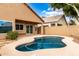 Inviting backyard pool features a curved design and a spacious patio area for outdoor relaxation and entertaining at 1447 E Nighthawk Way, Phoenix, AZ 85048