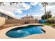 Backyard view showcasing a refreshing pool, lush greenery, and an inviting outdoor space at 1447 E Nighthawk Way, Phoenix, AZ 85048