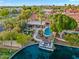 Aerial view of a waterfront property featuring a pool, backyard with fire pit, boat dock, and mature landscaping at 1457 W Bahia Ct, Gilbert, AZ 85233