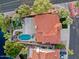 Aerial view of a luxury home featuring a red tile roof, boat dock, pool, backyard, and mature landscaping at 1457 W Bahia Ct, Gilbert, AZ 85233