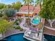 Beautiful backyard oasis with a sparkling pool, covered patio with string lights, and a private boat dock at 1457 W Bahia Ct, Gilbert, AZ 85233