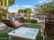 Beautiful backyard with water views, lounge chairs, and lush landscaping at 1457 W Bahia Ct, Gilbert, AZ 85233
