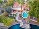 Gorgeous backyard featuring an in-ground pool, covered patio, a relaxing fire pit, and a private boat dock at 1457 W Bahia Ct, Gilbert, AZ 85233