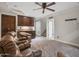 Large basement space with plush carpeting, ceiling fan, custom cabinets and comfortable seating at 1457 W Bahia Ct, Gilbert, AZ 85233