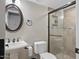 Cozy bathroom with glass shower, oval mirror and pedestal sink at 1457 W Bahia Ct, Gilbert, AZ 85233