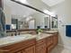 Bathroom vanity featuring double sinks, granite countertops, and dark wood cabinets at 1457 W Bahia Ct, Gilbert, AZ 85233