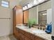 Spacious bathroom with double sinks, granite countertop, and a large mirror reflecting natural light at 1457 W Bahia Ct, Gilbert, AZ 85233