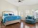Spacious bedroom with a king-sized bed, hardwood floors, and natural light at 1457 W Bahia Ct, Gilbert, AZ 85233