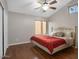 Bedroom featuring hardwood floors, ceiling fan, closet, and bright windows at 1457 W Bahia Ct, Gilbert, AZ 85233