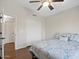Bedroom featuring hardwood floors, ceiling fan, and closet with sliding doors at 1457 W Bahia Ct, Gilbert, AZ 85233