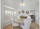 Cozy dining nook with white chairs, a round table, and bright natural light at 1457 W Bahia Ct, Gilbert, AZ 85233
