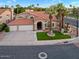 Charming two-story home featuring a three-car garage, tile roof, arched entry, and lush landscaping at 1457 W Bahia Ct, Gilbert, AZ 85233