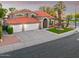 Attractive two-story home featuring a three-car garage, arched entryway, tiled roof, and mature landscaping at 1457 W Bahia Ct, Gilbert, AZ 85233