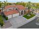 Exterior view of a two-story home featuring a three-car garage, tiled roof, and manicured front lawn at 1457 W Bahia Ct, Gilbert, AZ 85233