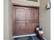 Close up on the stunning, arched double front doors and decorative vases flanking each side at 1457 W Bahia Ct, Gilbert, AZ 85233