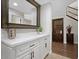 Hallway view with white storage, hardwood flooring, grand mirror and staircase with wood railing at 1457 W Bahia Ct, Gilbert, AZ 85233