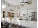 Bright kitchen features white cabinets, stainless steel refrigerator and a quartz countertop with bar stool seating at 1457 W Bahia Ct, Gilbert, AZ 85233