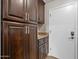 Laundry area features rich wood cabinetry and ample storage at 1457 W Bahia Ct, Gilbert, AZ 85233