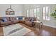 Bright living room featuring a large sectional sofa, area rug and plantation shutters at 1457 W Bahia Ct, Gilbert, AZ 85233