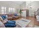 Open living area with wood floors, plantation shutters, and a comfortable sectional sofa at 1457 W Bahia Ct, Gilbert, AZ 85233
