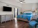 Light-filled main bedroom with wood floors and cozy seating at 1457 W Bahia Ct, Gilbert, AZ 85233