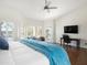 Well-lit bedroom with attached study, plush armchair, and views of the pool at 1457 W Bahia Ct, Gilbert, AZ 85233