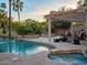 Inviting pool and spa with lush landscaping, covered patio, and lounge seating at 1457 W Bahia Ct, Gilbert, AZ 85233