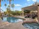 Relaxing pool and spa area with lounge chairs and a covered patio at 1457 W Bahia Ct, Gilbert, AZ 85233