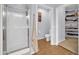 A bathroom with a tiled floor, glass-enclosed shower, toilet and doorway to closet at 14575 W Mountain View Blvd # 11315, Surprise, AZ 85374