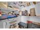 Walk-in closet features ample shelving and hanging storage space for optimized organization solutions at 14575 W Mountain View Blvd # 11315, Surprise, AZ 85374