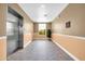 Well-lit hallway with elevator, tile flooring, and a window offering natural light and views at 14575 W Mountain View Blvd # 11315, Surprise, AZ 85374