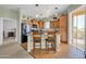 This kitchen features wood cabinets, stainless appliances and a center island with room for seating and a slider to the balcony at 14575 W Mountain View Blvd # 11315, Surprise, AZ 85374