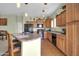 Bright kitchen with breakfast bar, oak cabinetry, and black appliances at 14575 W Mountain View Blvd # 11315, Surprise, AZ 85374