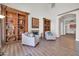 Inviting living room with built-in bookshelves, a fireplace, and comfortable seating, with an arched doorway at 14575 W Mountain View Blvd # 11315, Surprise, AZ 85374