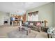 Open living area with comfortable sofa, view of the kitchen, and bright natural light at 14575 W Mountain View Blvd # 11315, Surprise, AZ 85374